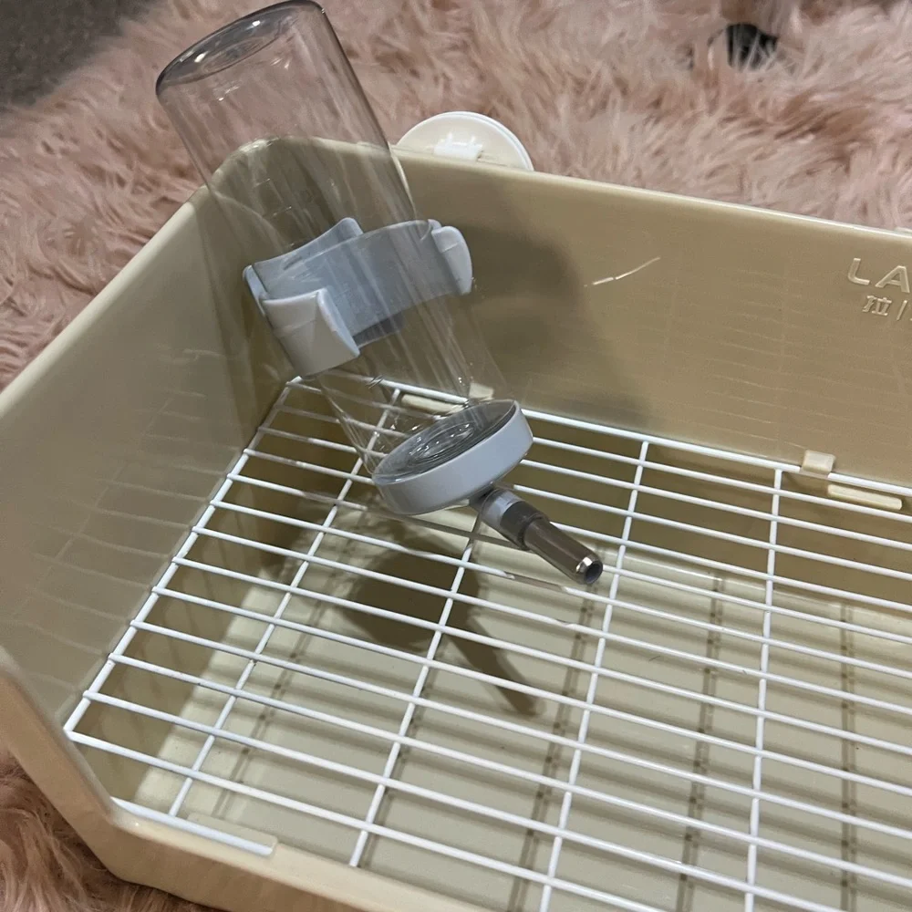 Small pets litter box and water bottle.